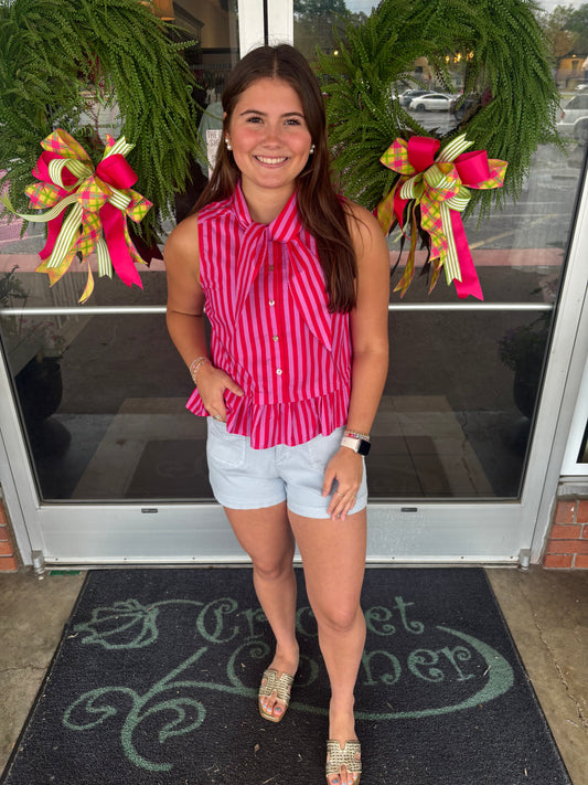 Striped sleeveless peplum top featuring tie neck detail